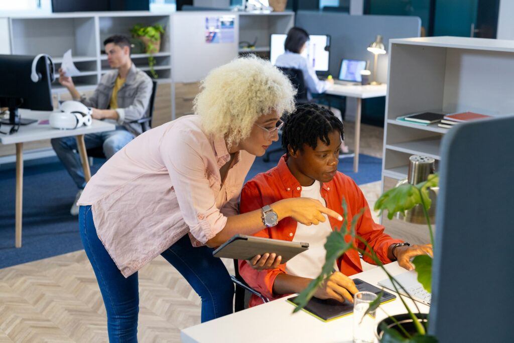 Biracial woman and African American man team up on startup tech project in business